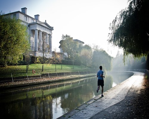 active male runner jogging in park setting